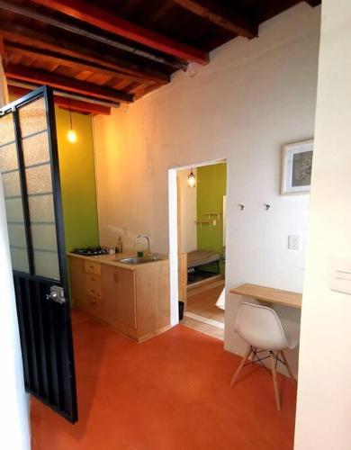 a kitchen with a sink and a table and a chair at chill green beautiful downtown area TV good Wifi in Oaxaca City