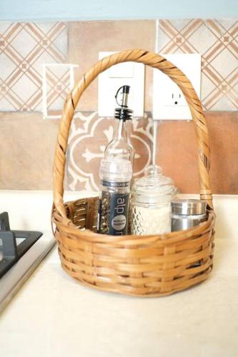 a basket with two bottles of water and condiments on a counter at Laidback tradicional centric Wifi AC TV Terrace in Oaxaca City