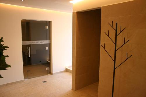 a hallway with a door with a tree design on it at Alphotel Innsbruck in Innsbruck