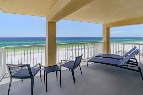 a balcony with chairs and a table and the ocean at Four Points by Sheraton Destin - Fort Walton Beach in Fort Walton Beach