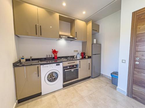 a kitchen with a washing machine and a washer at TheCasaEdition - Gueliz Residency in Marrakech