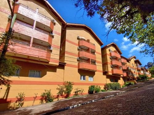 a large building with red and yellow at Sky Ville Hotel Canela in Canela