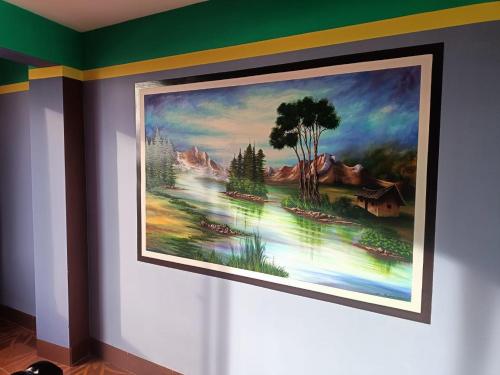 a painting hanging on a wall in a room at Backpacker Nexus Mirasol in Copacabana