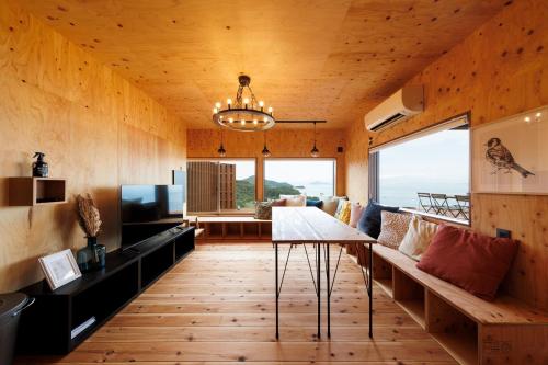 a living room with a table and a couch at 縹茫-Hyoubou- in Mitoyo