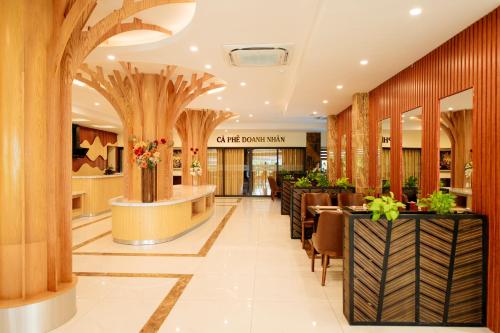 a lobby of a shopping mall with wooden columns at Quảng Ninh Gate Hotel & Resort in Bác Mã