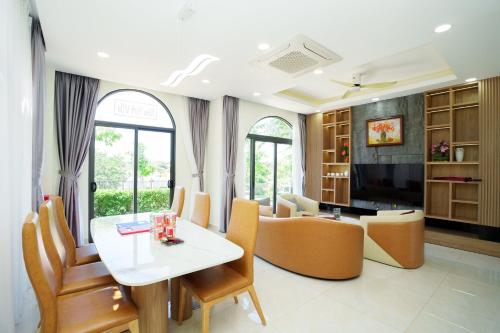 a living room with a table and chairs at Happy Stay Resort Wonderland Ho Tram in Xuyên Mộc