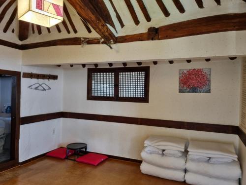 a living room with a couch and a window at Gohyundang in Jeonju