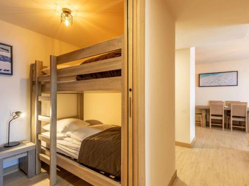 a bedroom with a bunk bed and a dining room at Luxueux 3 pièces aux Arcs 1600 avec piscine et spa, wifi, parking couvert, skis aux pieds - FR-1-461A-16 in Arc 1600