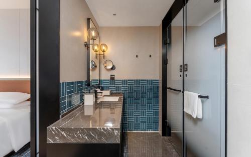 a hotel bathroom with a sink and a mirror at Four Points by Sheraton Dali, Erhai in Dali