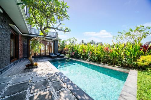 a swimming pool in the backyard of a house at Panorama Paddy Paradise in Ubud