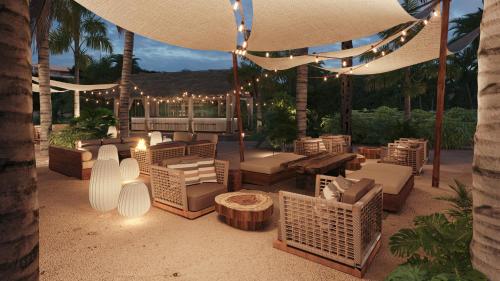 a patio with couches and tables and lights at Secrets Saint Lucia Resort & Spa - All Inclusive in Gros Islet