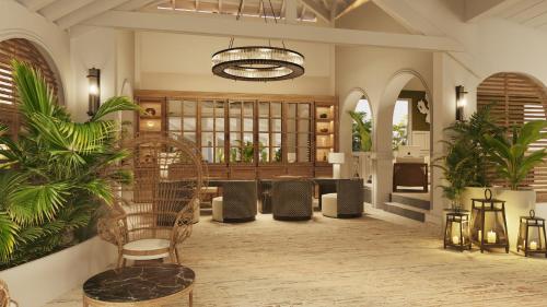 a lobby with chairs and plants and a chandelier at Secrets Saint Lucia Resort & Spa - All Inclusive in Gros Islet