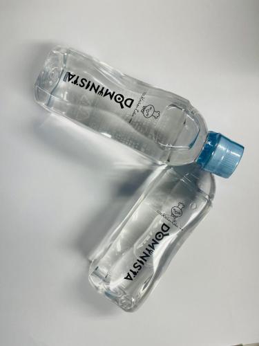 a plastic bottle laying on its side on a table at Dormy Inn Premium Namba Natural Hot Spring in Osaka