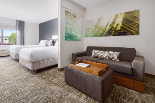 a hotel room with a bed and a couch at SpringHill Suites Manchester-Boston Regional Airport in Manchester
