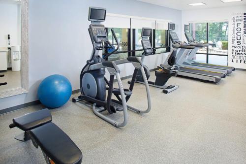 a gym with a row of treadms and cardio machines at SpringHill Suites Manchester-Boston Regional Airport in Manchester