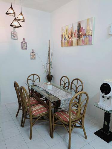 a dining room with a table and chairs at Adempuri homestay in Jitra