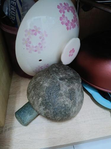 a rock sitting on a table next to an eggplant at Adempuri homestay in Jitra