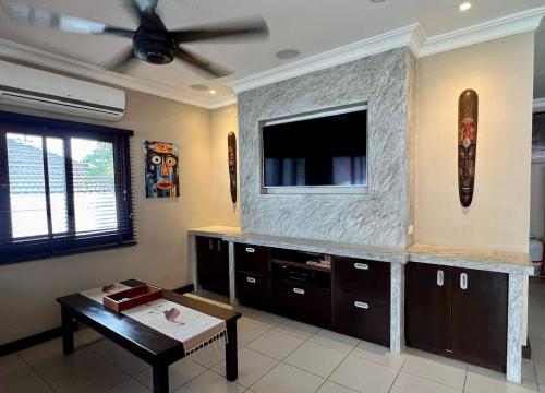 a living room with a flat screen tv on a wall at Jitsin Villa Koh Tao in Koh Tao