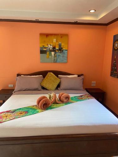 a bed with two donuts on top of it at Thai Smile Bungalows in Ko Lanta