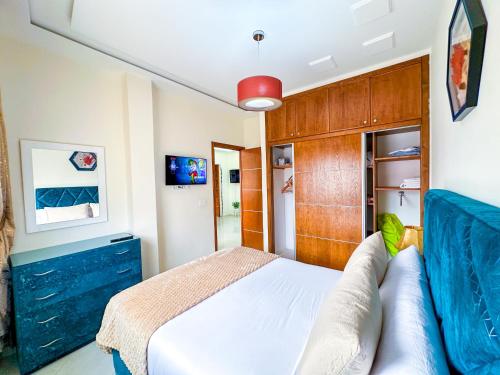 a bedroom with a bed and a couch at Elite Holiday Home - Luxury & Centric Flat in Tangier