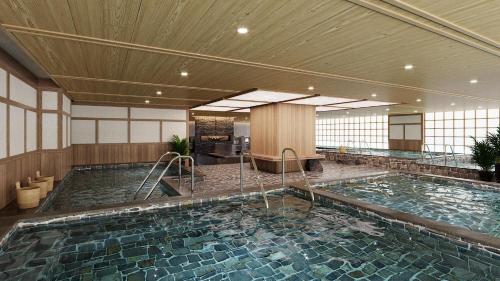 a large swimming pool in a hotel room at Flamingo Resort Cat Ba in Cat Ba