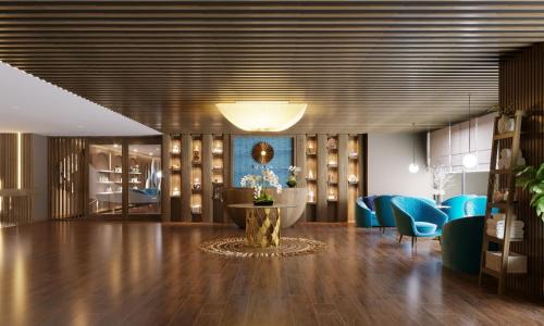 a lobby with a table and blue chairs at Flamingo Resort Cat Ba in Cat Ba
