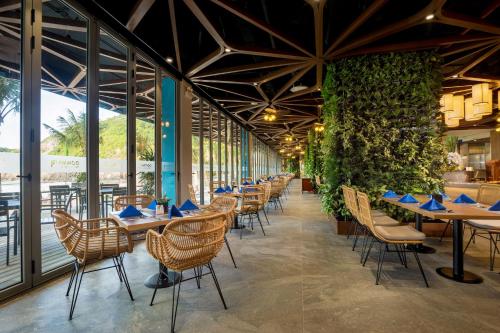 a row of tables and chairs in a restaurant at Flamingo Resort Cat Ba in Cat Ba