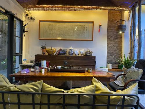 a room with a table and chairs in a room at Waiting for the Blossoms B&B Tea House in Shantou