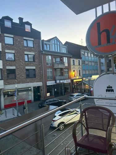 a balcony with a car parked in a parking lot at Hotel Am Markt in Eschweiler