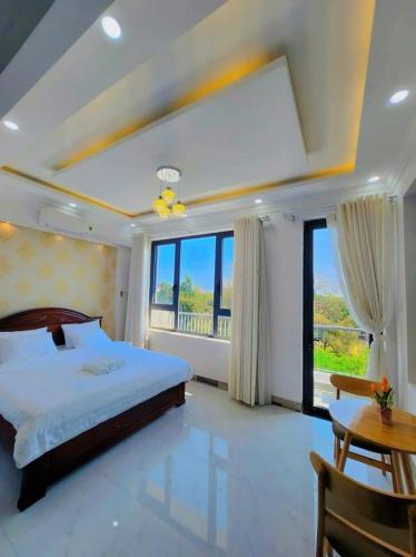 a bedroom with a large bed and a large window at Apec Sunsea Homestay in Liên Trì (3)