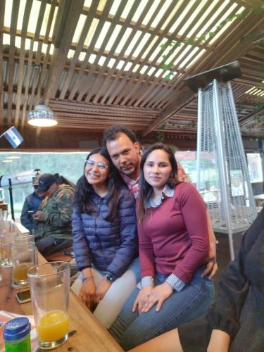 a man and two women sitting at a table at Cabaña 79 Papallacta Alpina in Papallacta