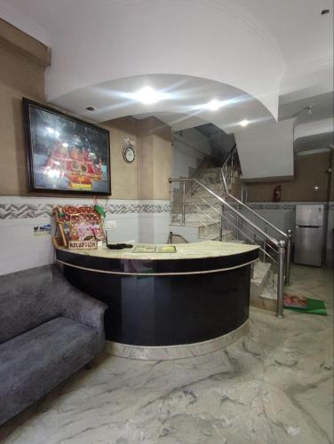 a large lobby with a round table and a staircase at Hotel Ishaan International Near Yatra Parchi Counter in Katra
