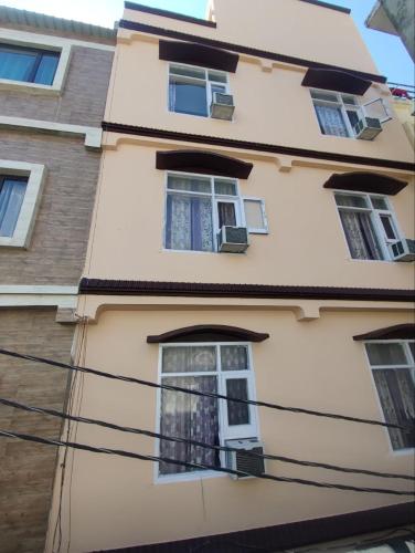 a building with windows on the side of it at Hotel Ishaan International Near Yatra Parchi Counter in Katra