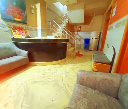 a living room with a staircase and a room with a rug at Hotel Ishaan International Near Yatra Parchi Counter in Katra