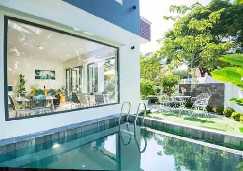 an image of a house with a swimming pool and a house at Hoi An Tháng 1 Villa in Hoi An