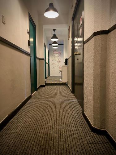 an empty hallway in an office building with ailed floor at Itinere Rooms in Granada