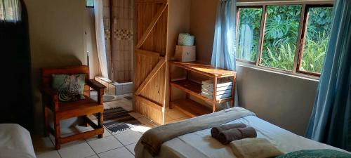 a small room with a bed and a window at Ikaya Accommodation PSJ in Port St Johns