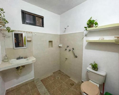 a bathroom with a toilet and a sink at Dicha Perfecta Telchac in Telchac Puerto