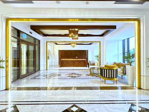 a living room with a large lobby with a fireplace at Ultra Luxury Flat with Amazing Pool Near to Burj in Dubai
