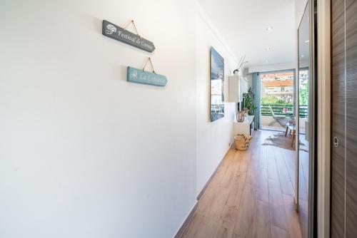 a hallway of a home with white walls and wooden floors at STUDIO by the croisette in Cannes