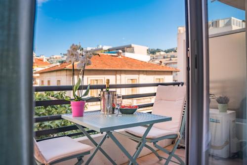 a table and chairs on a balcony with a view at STUDIO by the croisette in Cannes
