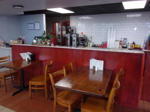 a dining room with two tables and a counter at Red Roof Inn Corpus Christi North - Near Downtown in Corpus Christi