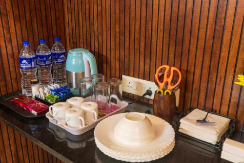 a counter with a table with bottles of water at Sancta Maria Airport Hotel in Cochin