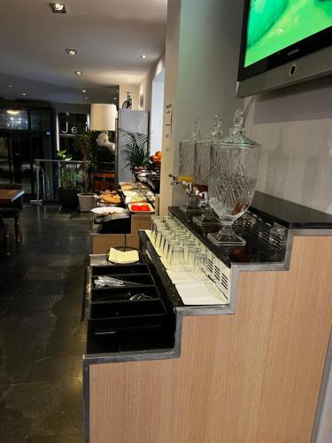 a kitchen with a counter with glasses on it at Hotel Aviation in Brussels