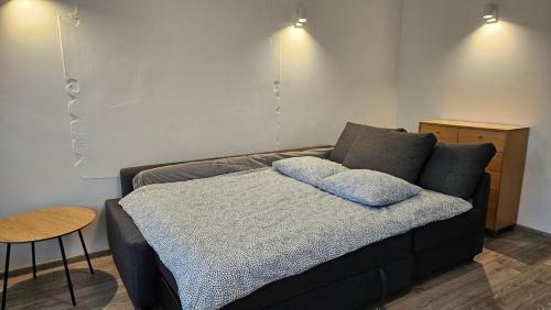 a couch with two pillows on it in a room at Draugyste Apartment in Šiauliai
