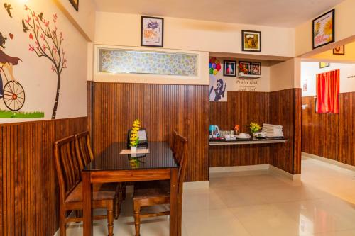 a dining room with a table and chairs at Sancta Maria Airport Hotel in Cochin