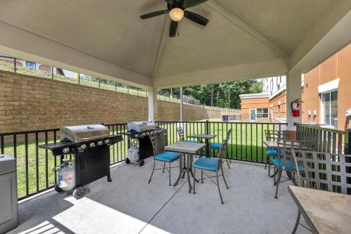 a patio with tables and chairs and a grill at Candlewood Suites - Dumfries - Quantico by IHG in Dumfries