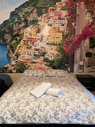 a bed with a view of the city of positano at B&b Pompei Window in Pompei