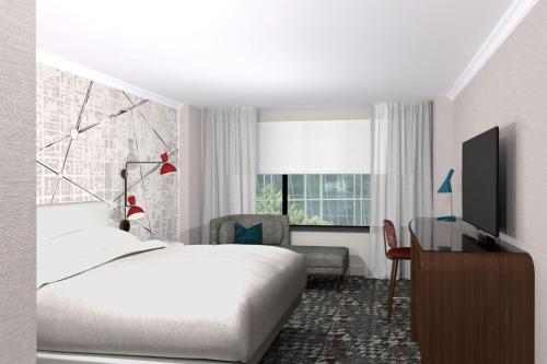 a bedroom with a bed and a desk and a television at Le Meridien Washington, DC, The Madison in Washington