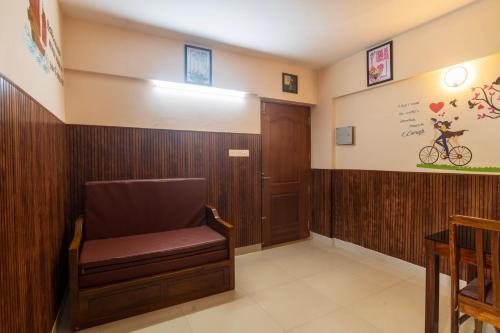 a waiting room with a chair and a bike on the wall at Sancta Maria Airport Hotel in Cochin